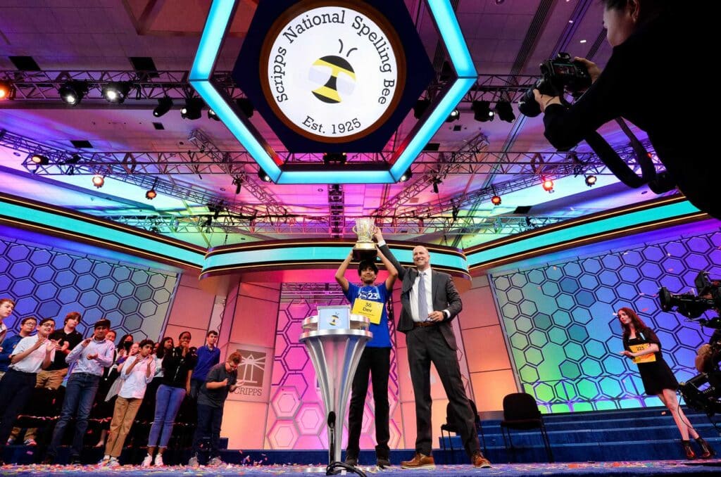 Dev Shah holds the spelling bee trophy