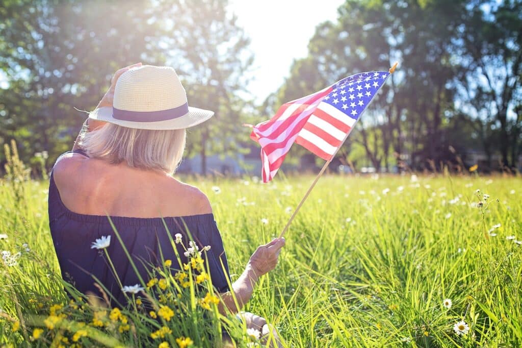 Women in a field with a flag