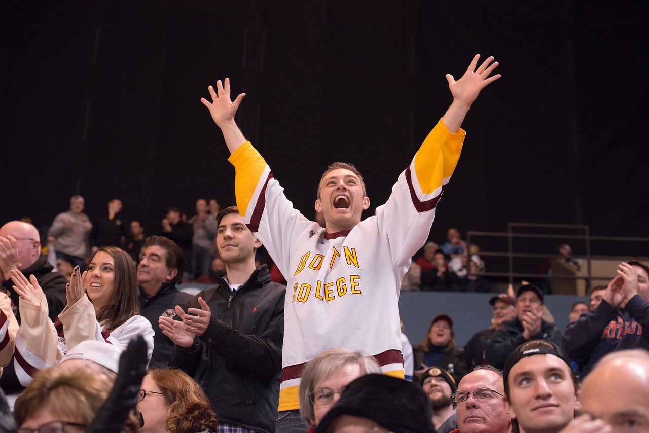 A hockey fan celebrates in the stands