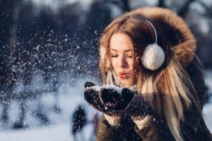 Woman blowing snow