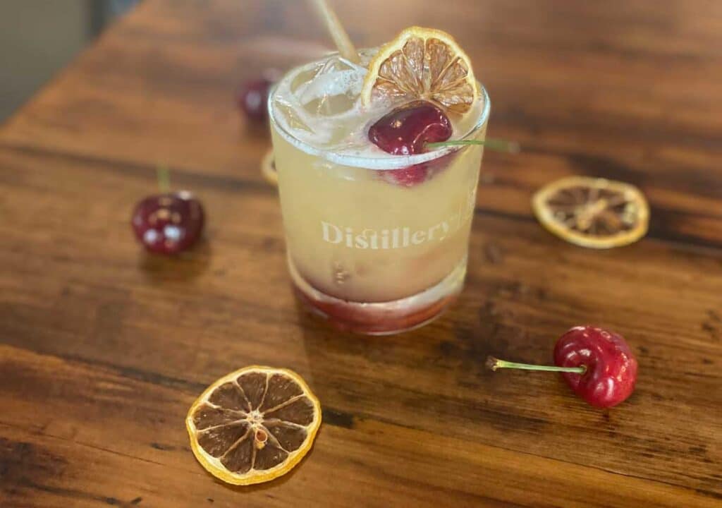 A mango cocktail sitting on a table