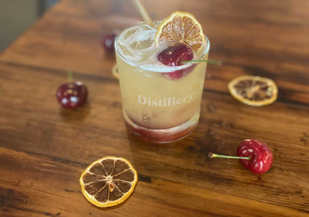 A mango cocktail sitting on a table